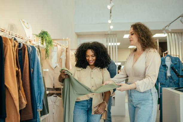istock Black woman looking at clothes in a store 2157490872