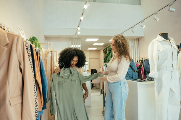 istock Black woman looking at clothes in a store 2157490875