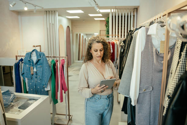 istock Entrepreneurial woman in her clothing store, using tablet 2157490901