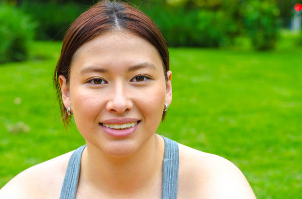 istock sportswoman taking a break from exercise looking at camera outdoors in public park in city 2157491482