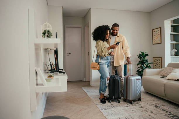 istock Couple leaving home with suitcases for travel 2157491541