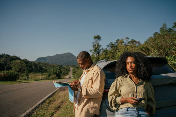 istock Husband looking at map while wife uses cell phone 2157491731