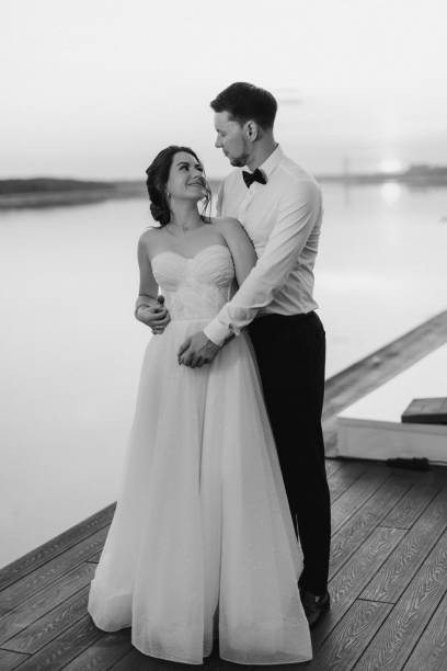 istock bride and groom against the backdrop of a yellow sunset 2157494002