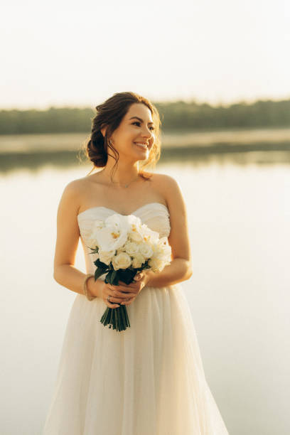 istock bride against the background of a yellow sunset 2157494846