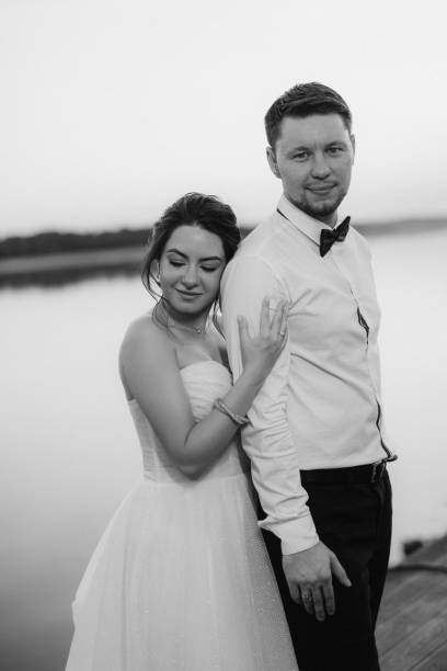 istock bride and groom against the backdrop of a yellow sunset 2157494881