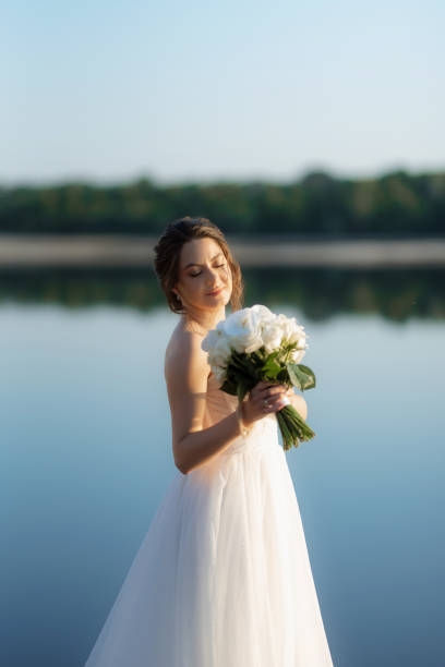 istock bride against the background of a yellow sunset 2157495233