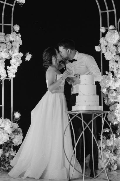 istock newlyweds happily cut and taste the wedding cak 2157495319