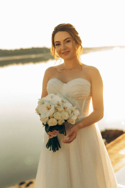 istock bride against the background of a yellow sunset 2157495510