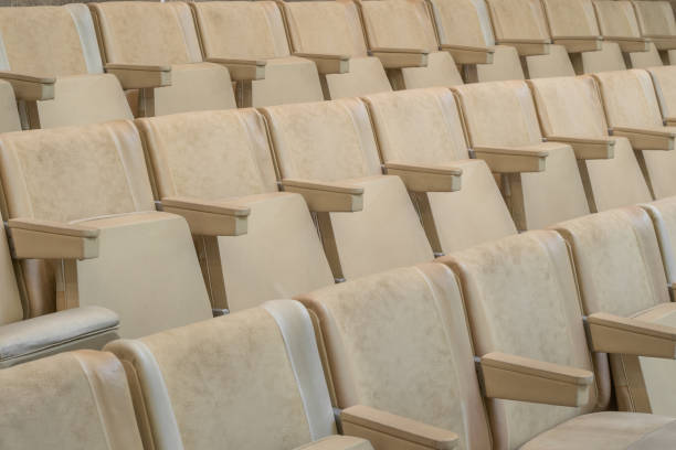 istock Empty rows of beige chairs in an assembly hall, close-up. 2157496270