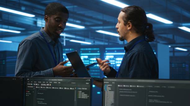 istock Coworkers examining equipment in data center, ensuring system security 2157497679