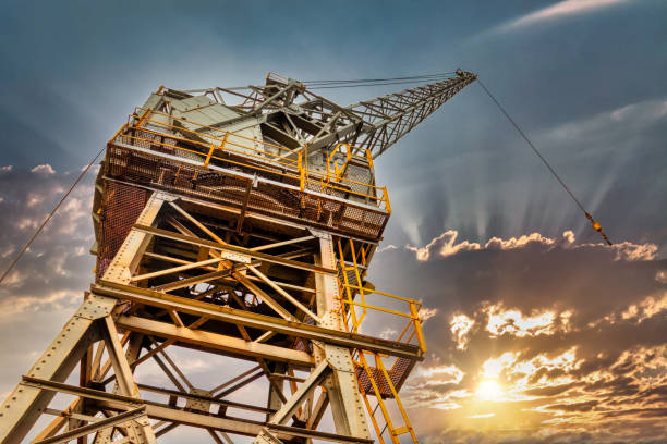 crane loading in a port, sunset sky in the backgrounds
