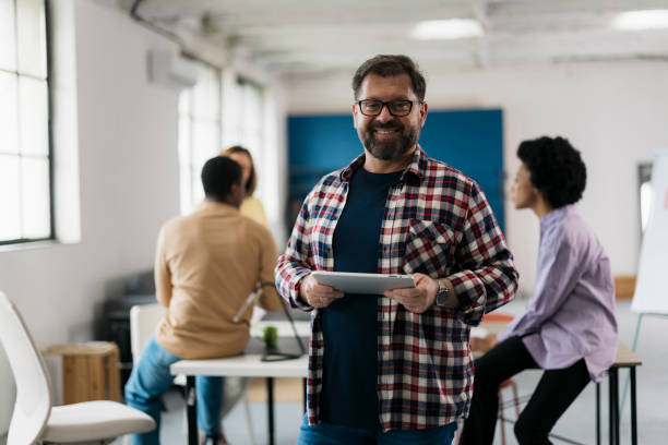 istock Businessman at startup with people discussing in background 2157499534