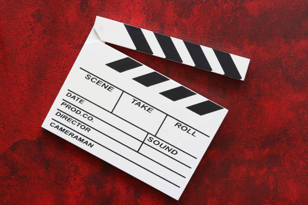 Stock photo showing close-up view of an open hinged clapper stick on a white film slate.
