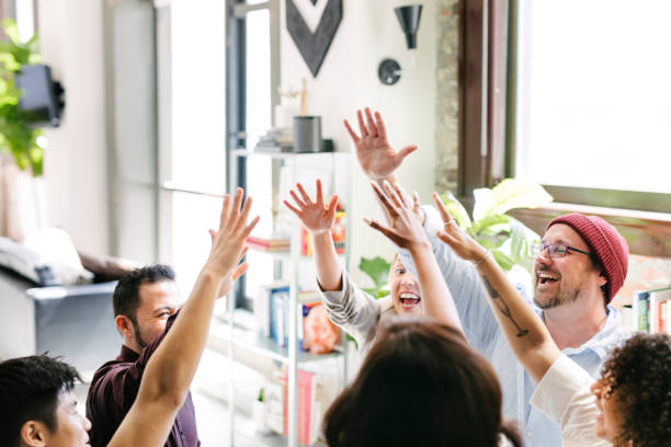 istock Happy diverse colleagues in a startup company doing a high five 2157502021