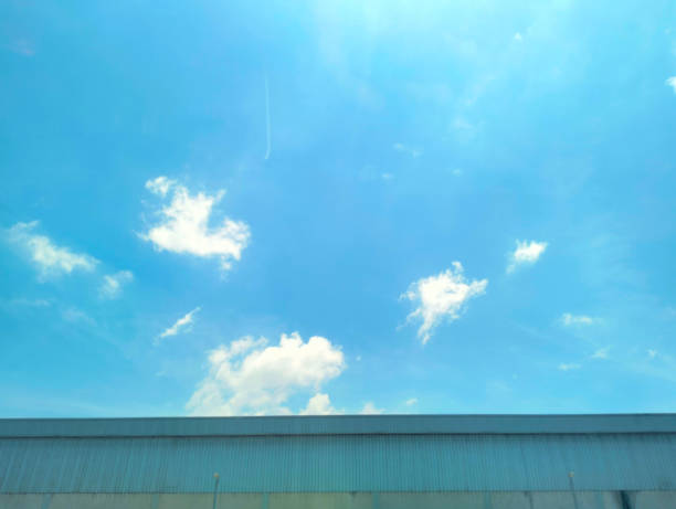 Roof of industry and cloud, sky light blue.