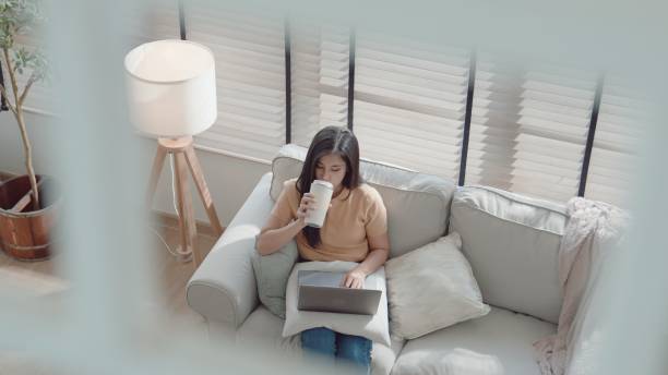 istock Asian young woman taking a break while working from home. 2157511123