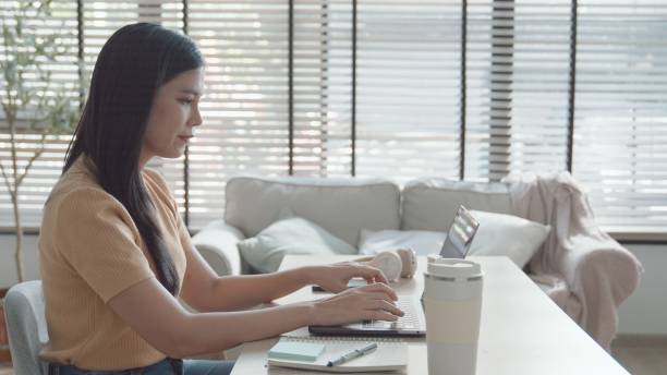 istock Asian young woman working from home,  e-learning at home 2157511525