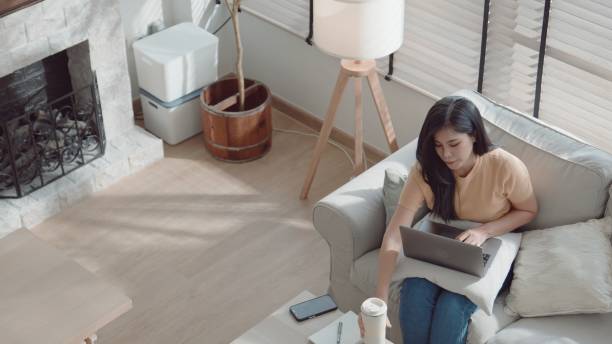istock Asian young woman taking a break while working from home. 2157511542