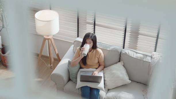 istock Asian young woman taking a break while working from home. 2157511785