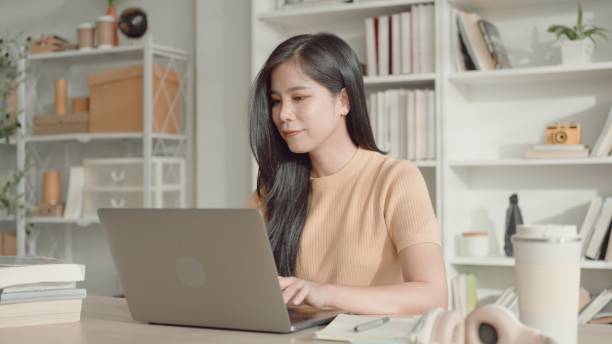 istock Asian young woman working from home,  e-learning at home 2157512247
