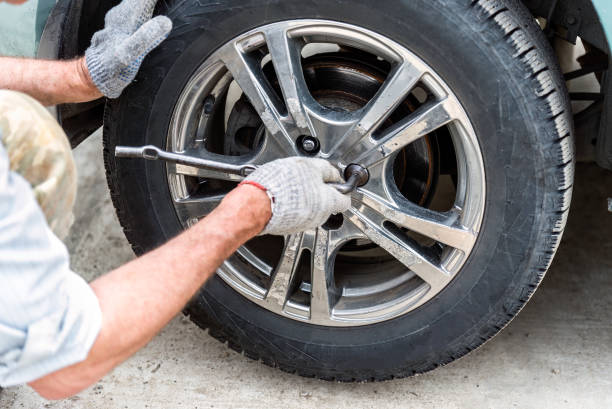 istock young man changing a car tire for winter tires 2157513163