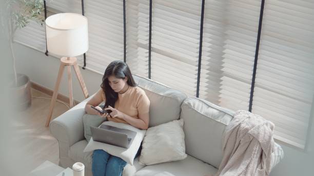 istock Asian woman using smartphone at home, working at home,virtual assistant 2157513272