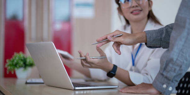 istock Business Team Analyze Data and Discuss strategy in a Modern Office Setting with Laptop and Documents 2157516929