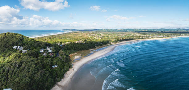 Witness the dramatic beauty of Byron Bay a day in summer, offering stunning views and a picturesque coastal landscape.