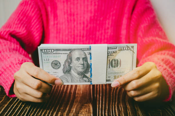 istock Female hands holding banknotes, finance concept 2157518281