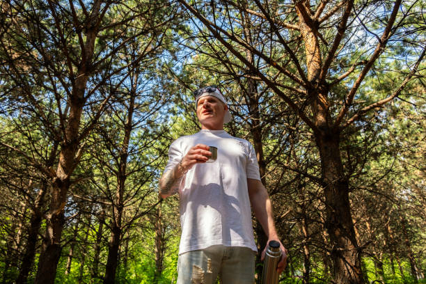 Man taking a break during walk in the woods.