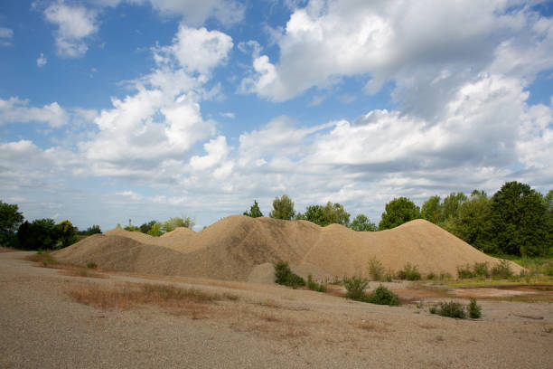 Gravel pyramid with cloud panorama, industrial concrete and stone crusher
