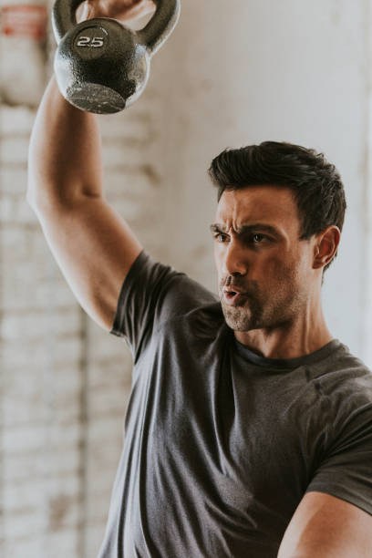 Sportive man lifting a kettlebell