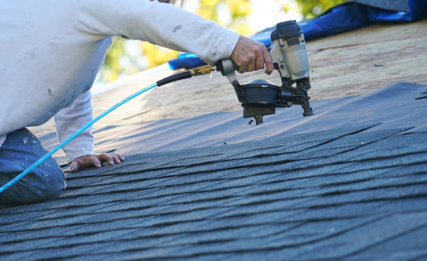 istock handyman using nail gun to install shingle to repair roof 2157522727