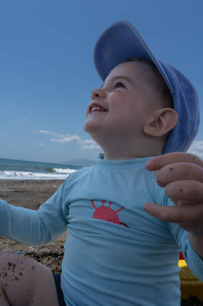 baby on the beach smiling and playing
