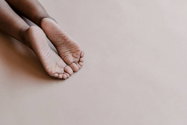 istock Female feet on beige background 2157524584