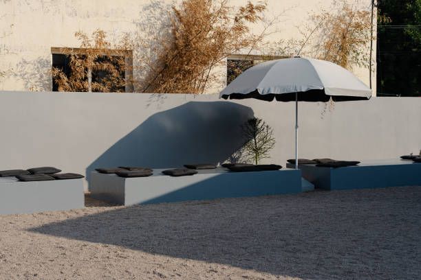 istock Outdoor seating area with umbrellas and cushions 2157527432