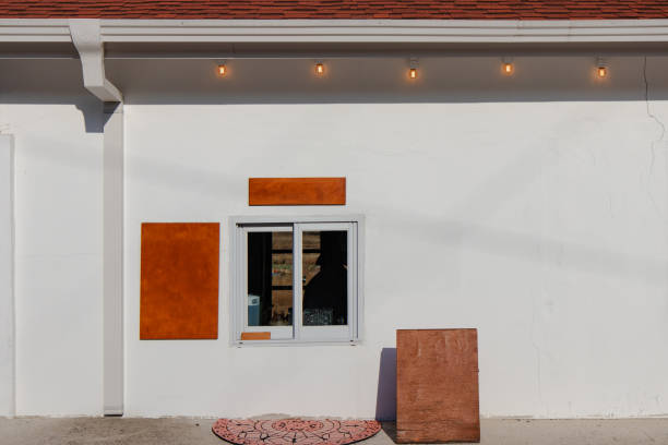 Minimalist White Wall with Orange Panels and Small Window