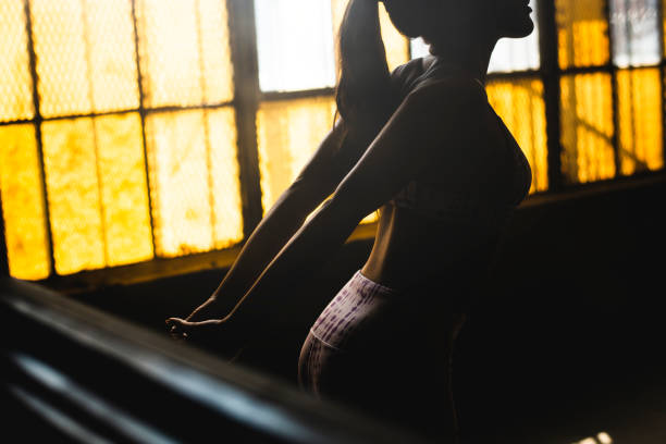 istock Woman stretching by the windows 2157530124