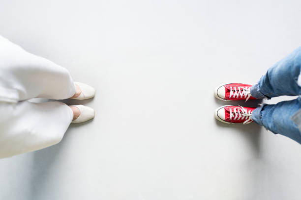 Friends standing with a space between themselves due to social distancing
