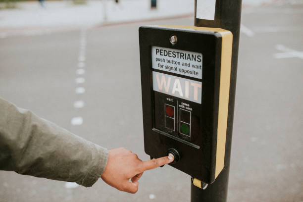 istock Person pressing a pedestrian cross push button 2157533194