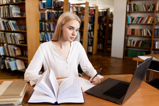 istock Education concept, female student in library, literature 2157534070