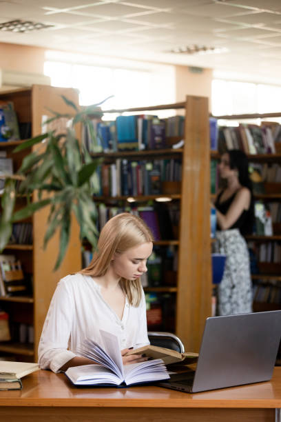istock Education concept, female student in library, literature 2157534074