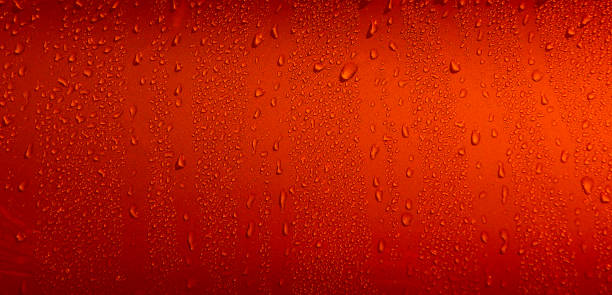 istock Red Water Drops Splashed On Flat Surface. Liquid drops on red Illustrative Stock Photo 2157536903