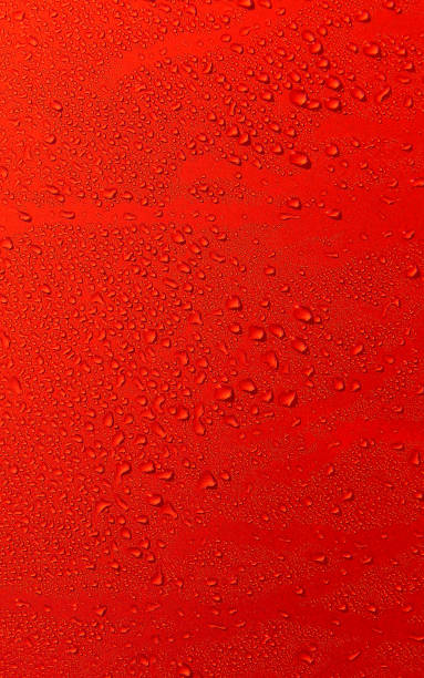 istock Pattern of water drops on red glossy surface. Stock Photo For Droplets Vertical Backgrounds 2157536916