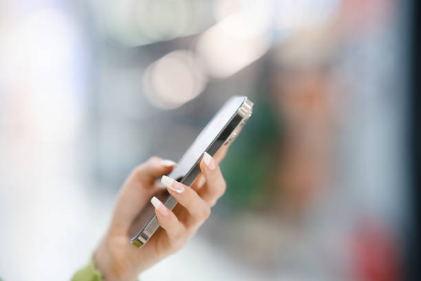 A young woman's hand holding a smartphone
