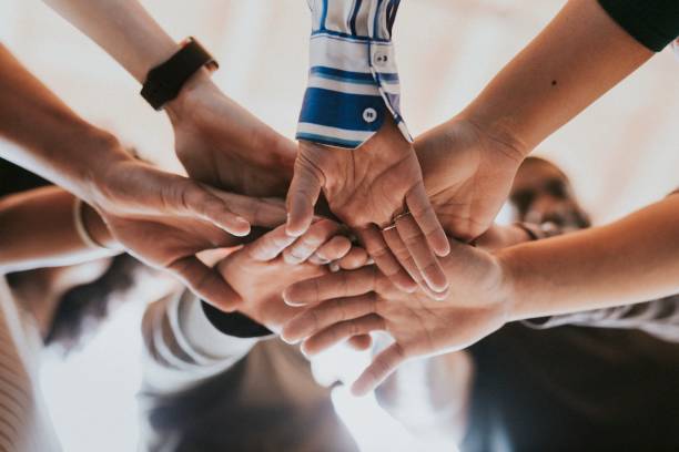 istock Group of diverse people stacking hands in the middle 2157539960