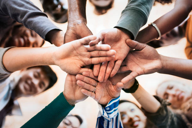 istock Group of diverse people stacking hands in the middle 2157539961