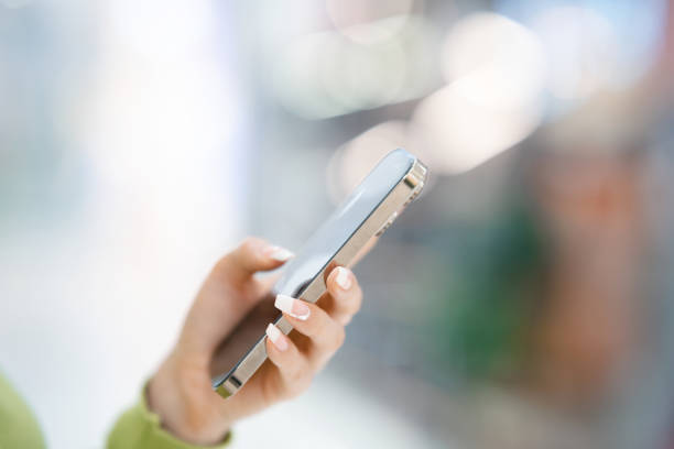 istock A young woman's hand holding a smartphone 2157539962