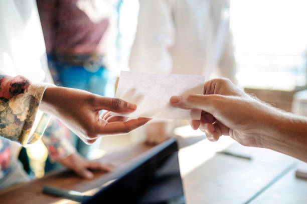 istock People getting a ballot at a polling place 2157540099
