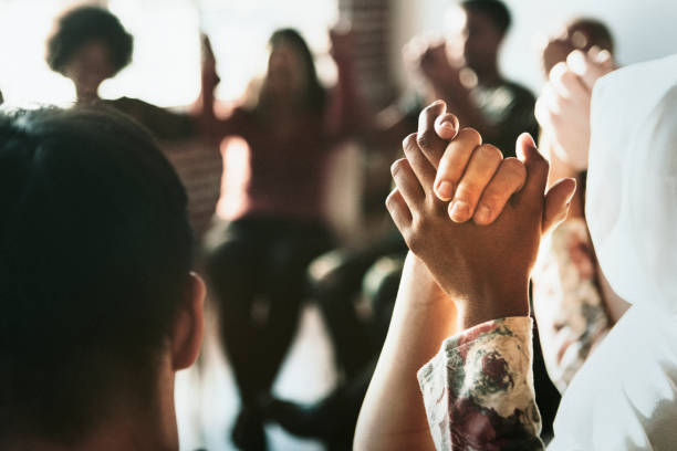 istock Group of diverse people holding hands up in the air 2157540630